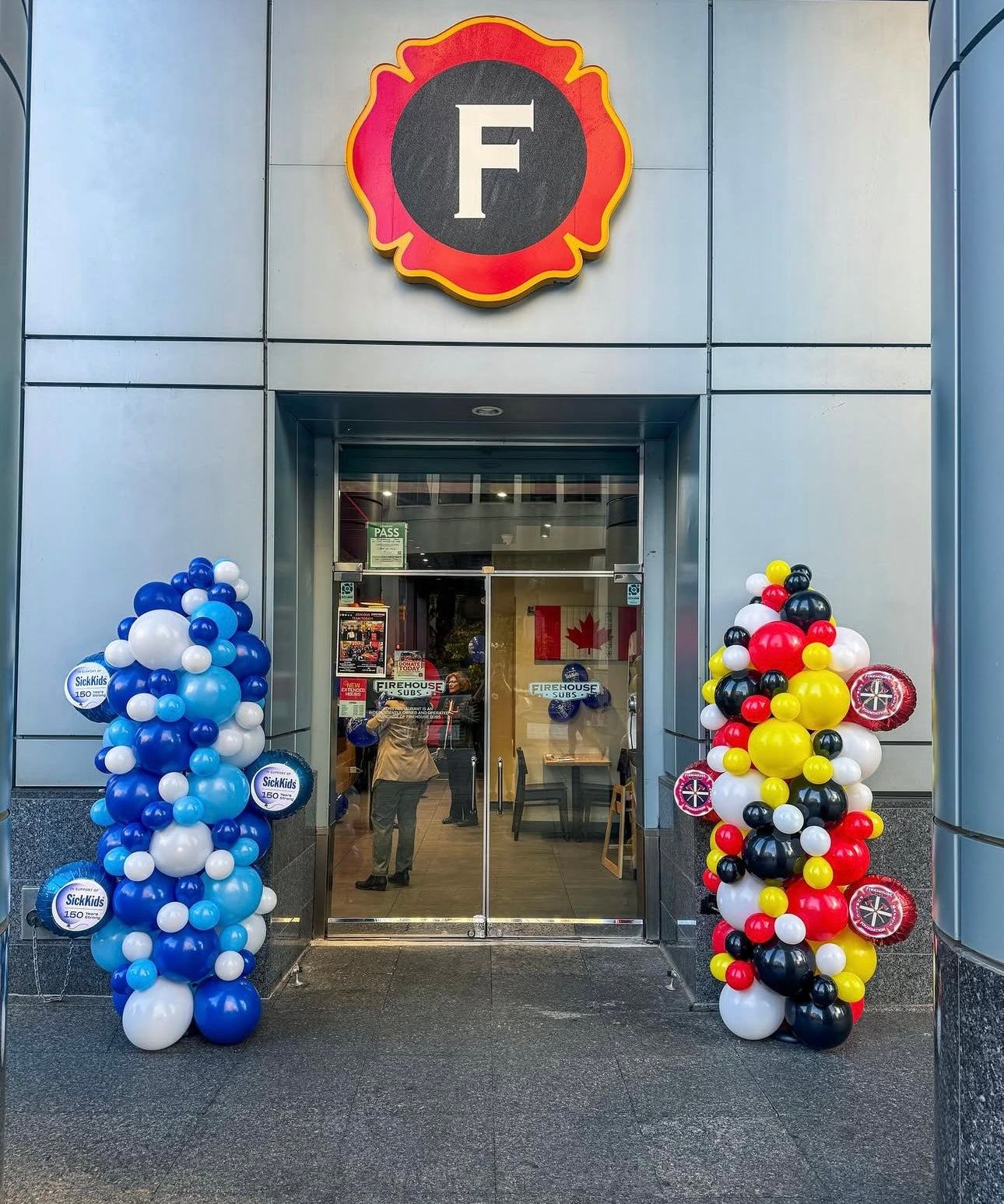 Two tall balloon pillars with logo foils