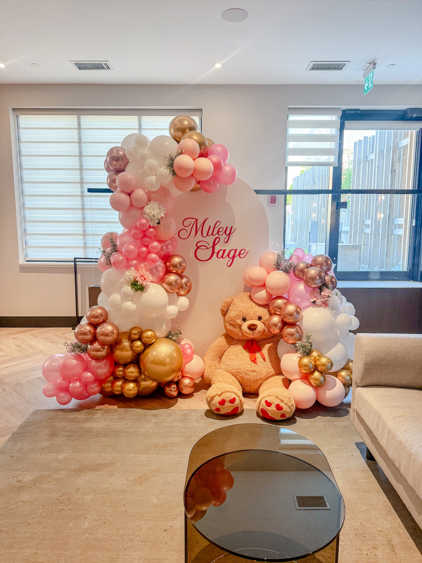 Large solid balloon filled backdrop with bear and floral