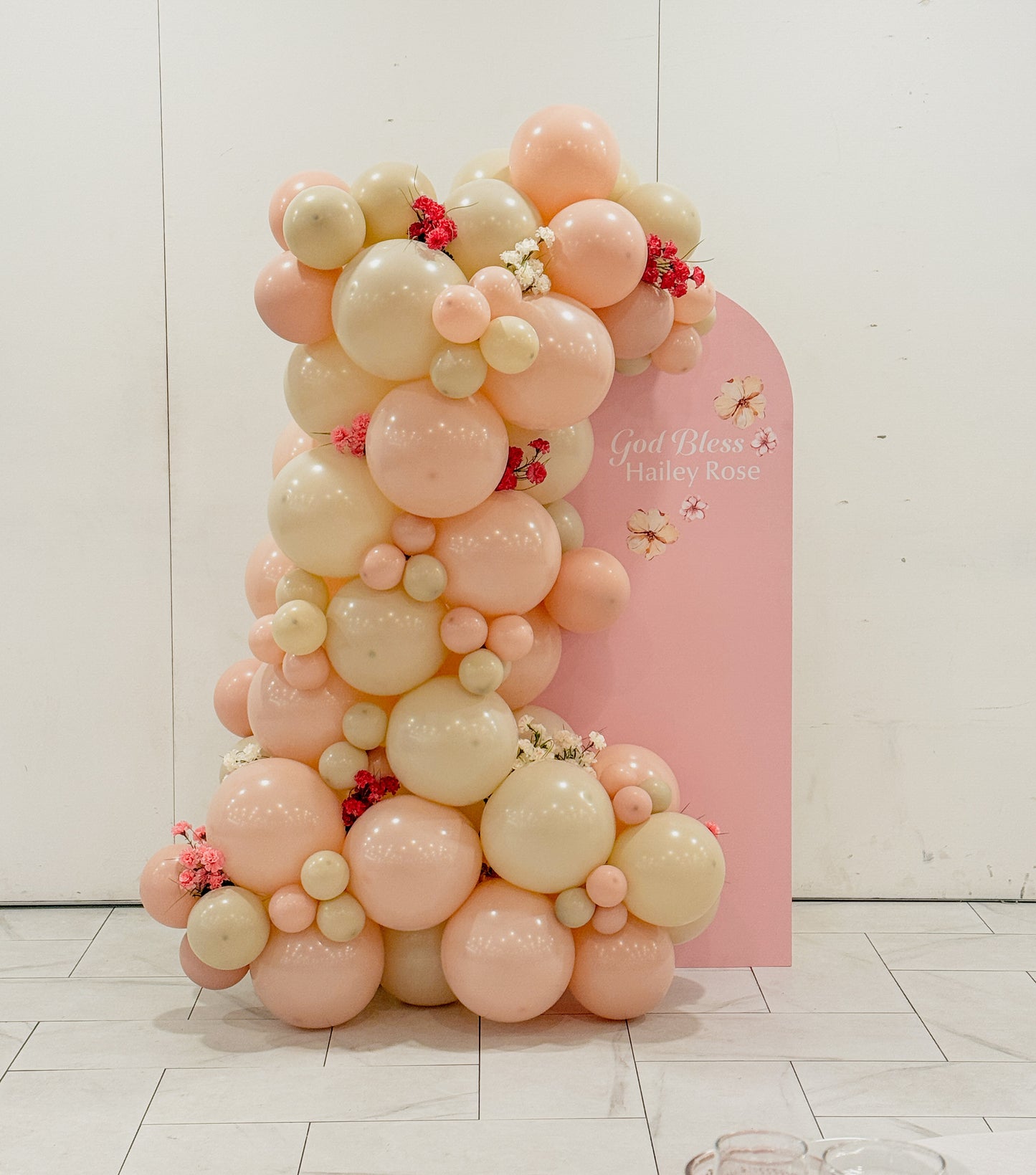 Mini solid backdrop with side balloons and floral accents