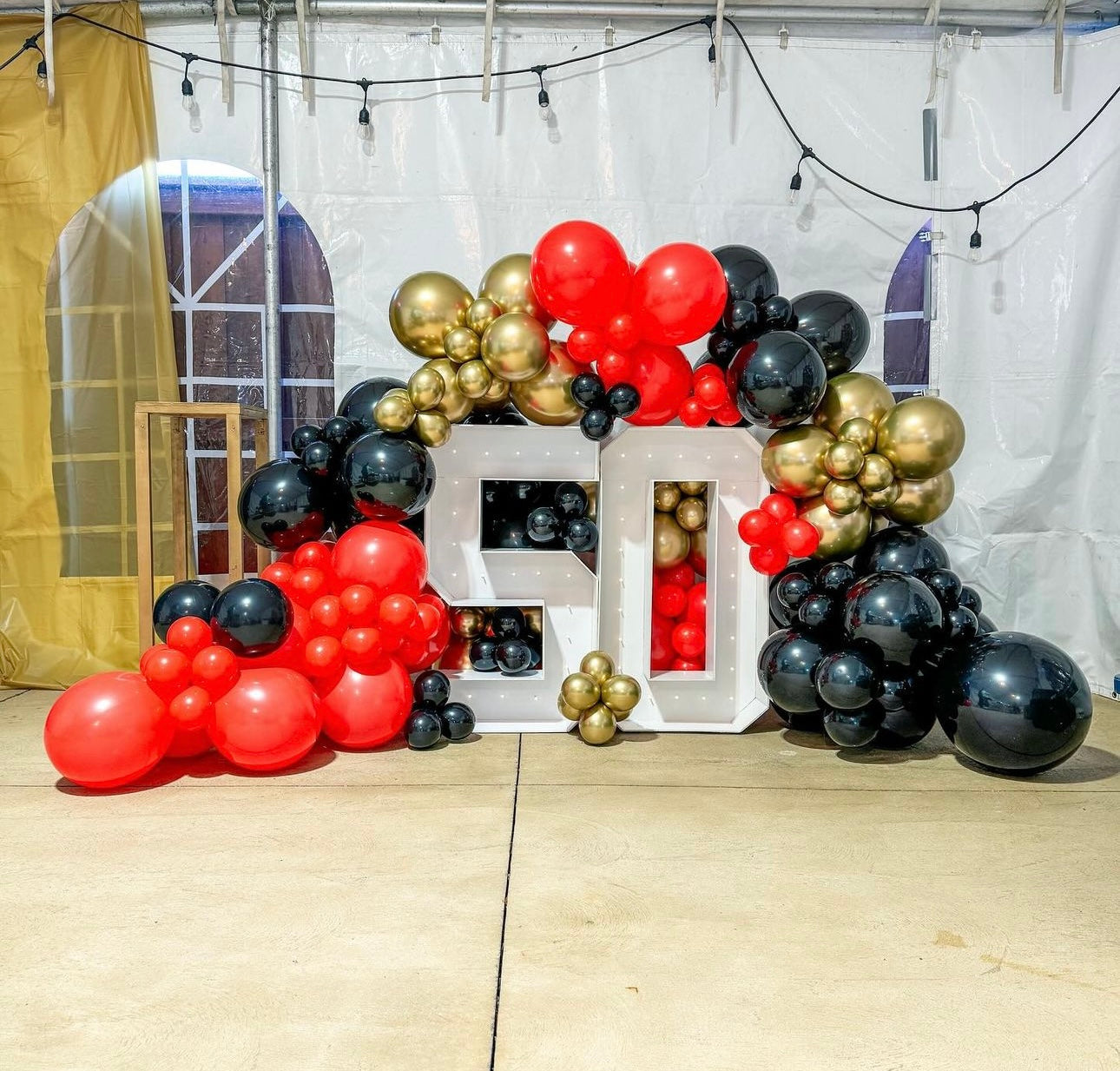 Two light up numbers with balloon garland