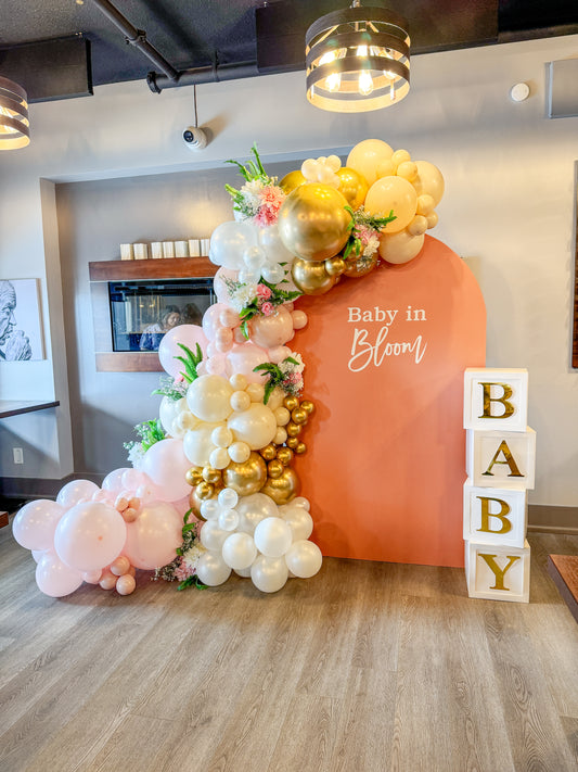 Large floral accented balloon display with baby boxes