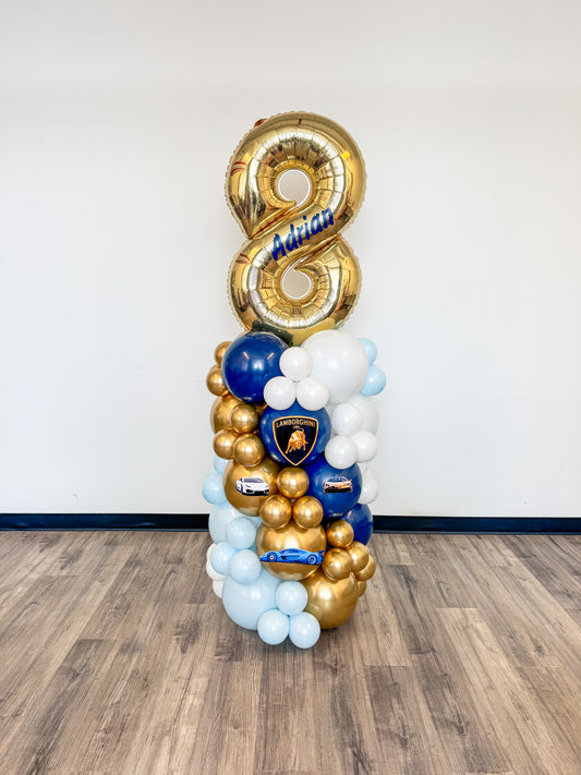 Aged balloon pillar with custom name and themed accents