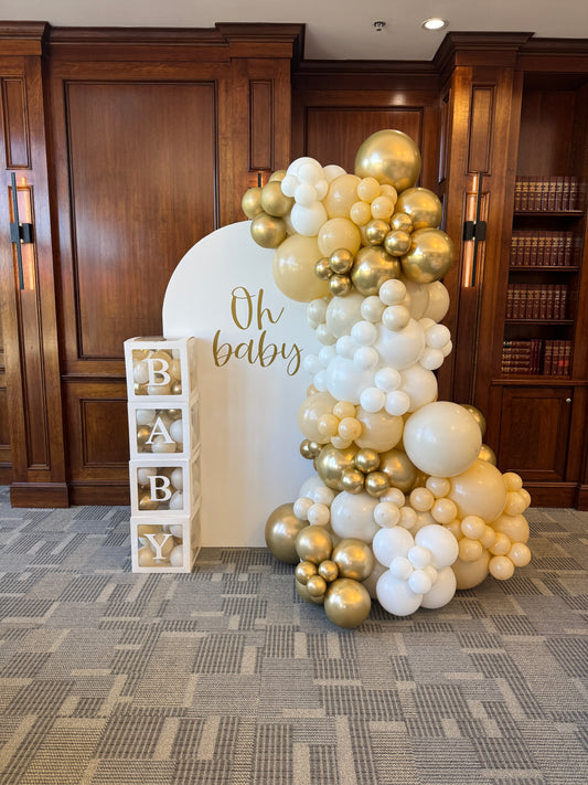 Large solid backdrop with lush side balloons & cake stand