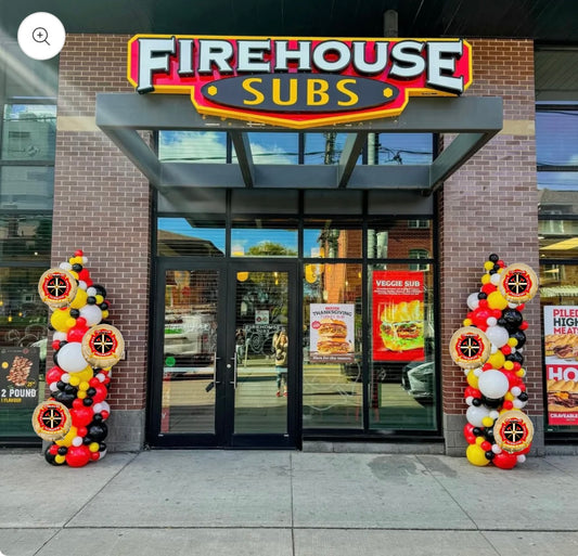 Two tall balloon pillars with logo foils