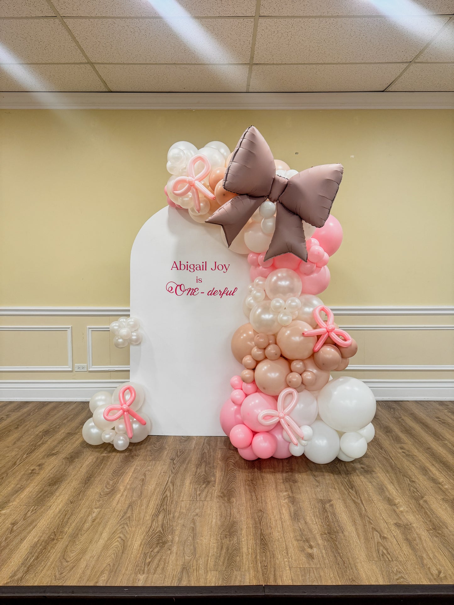 Large solid bow themed balloons backdrop