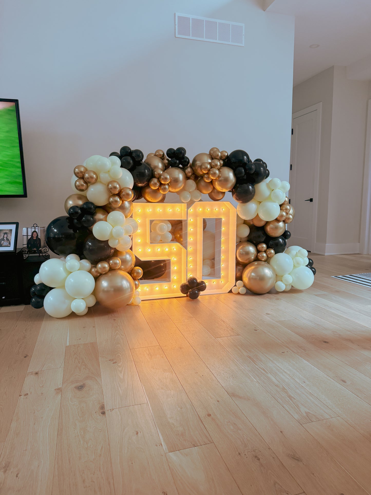 Two light up numbers with balloon garland