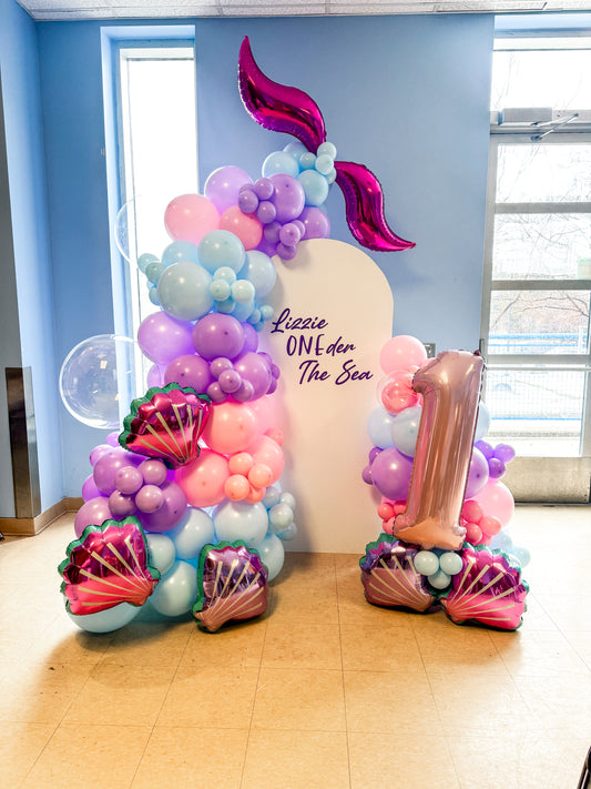 Middle solid white backdrop with a mermaid theme and foil number