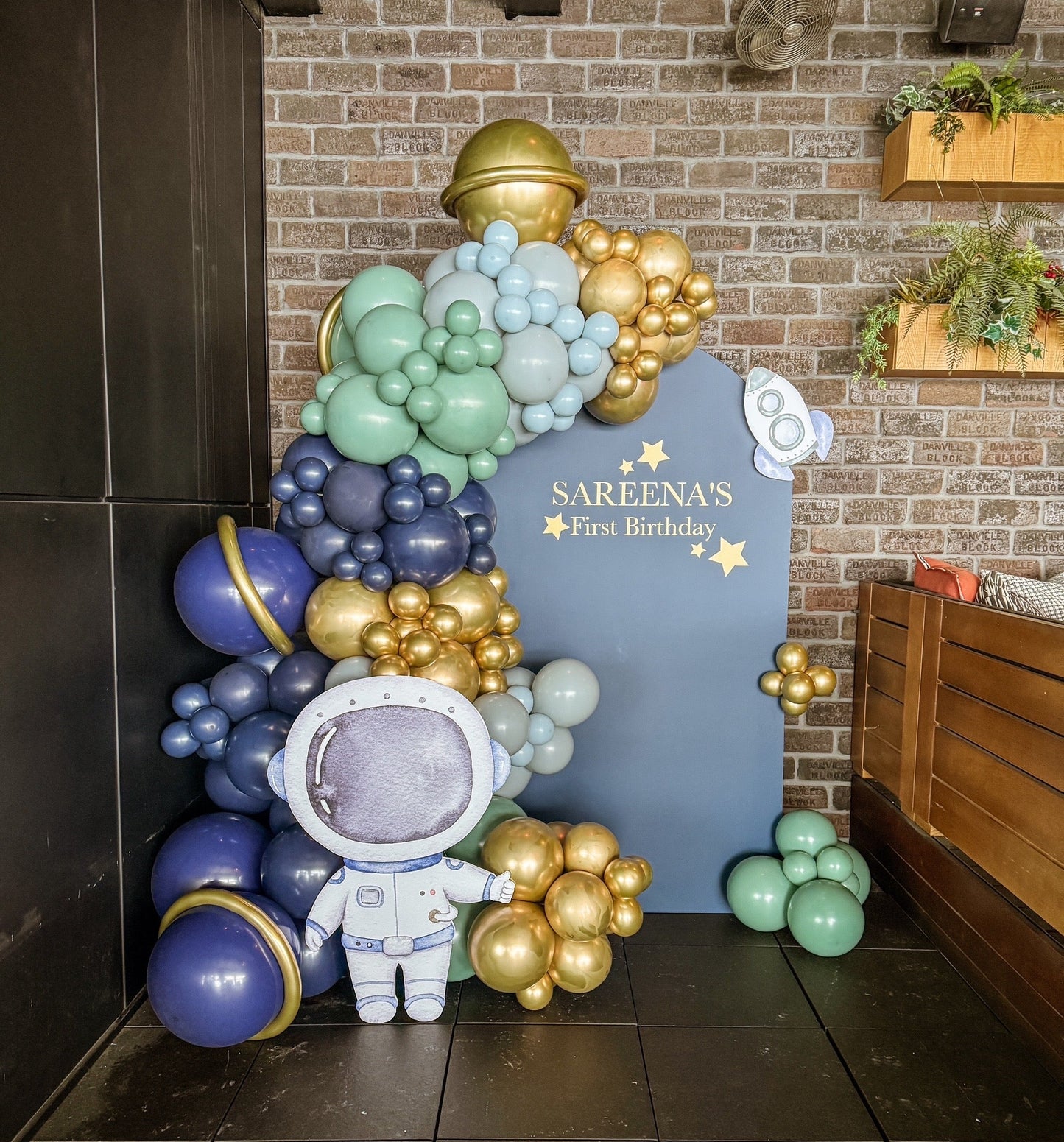 Themed large solid balloon backdrop with two props.