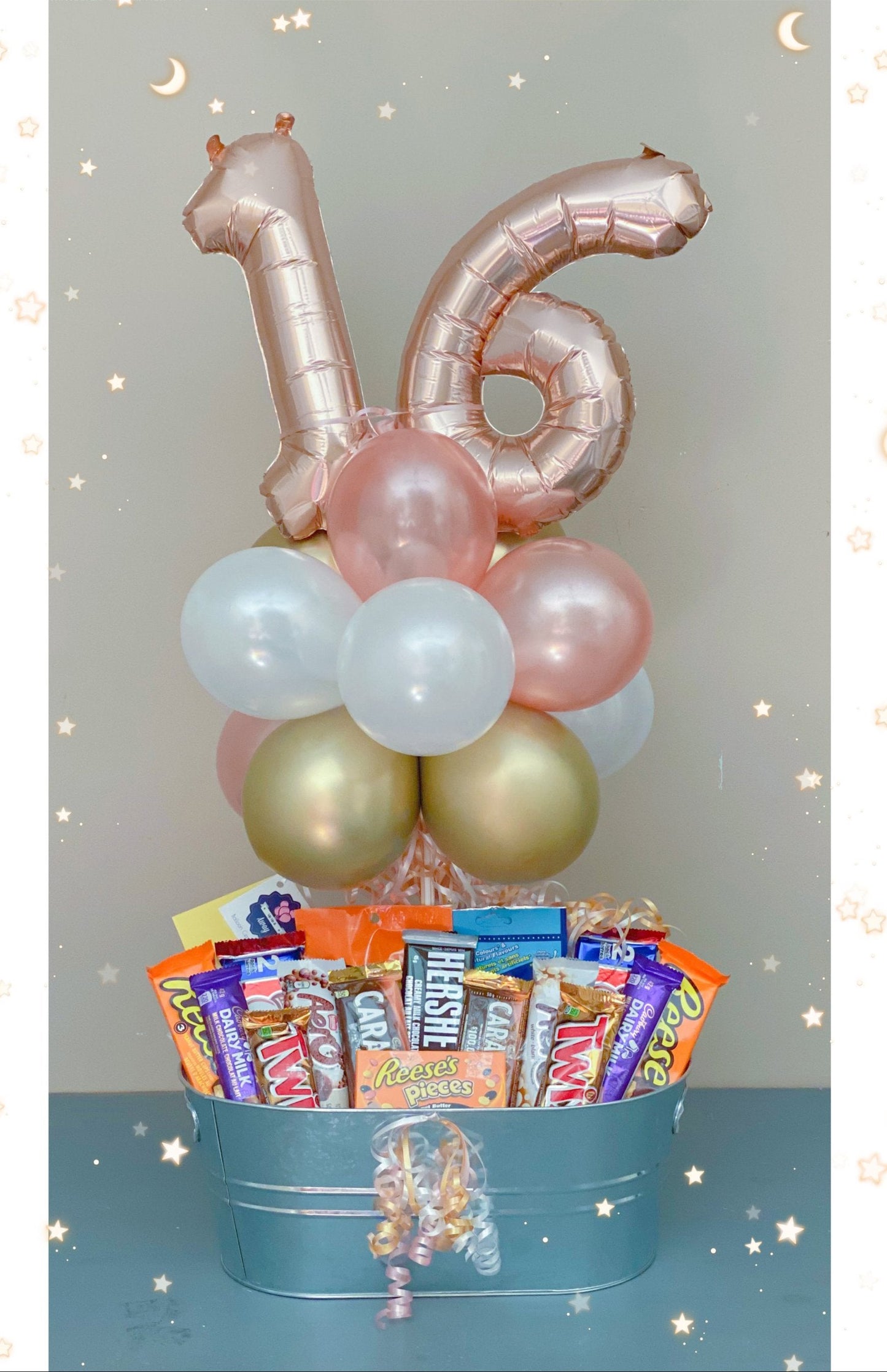 Number foil balloons with a large chocolate bar basket